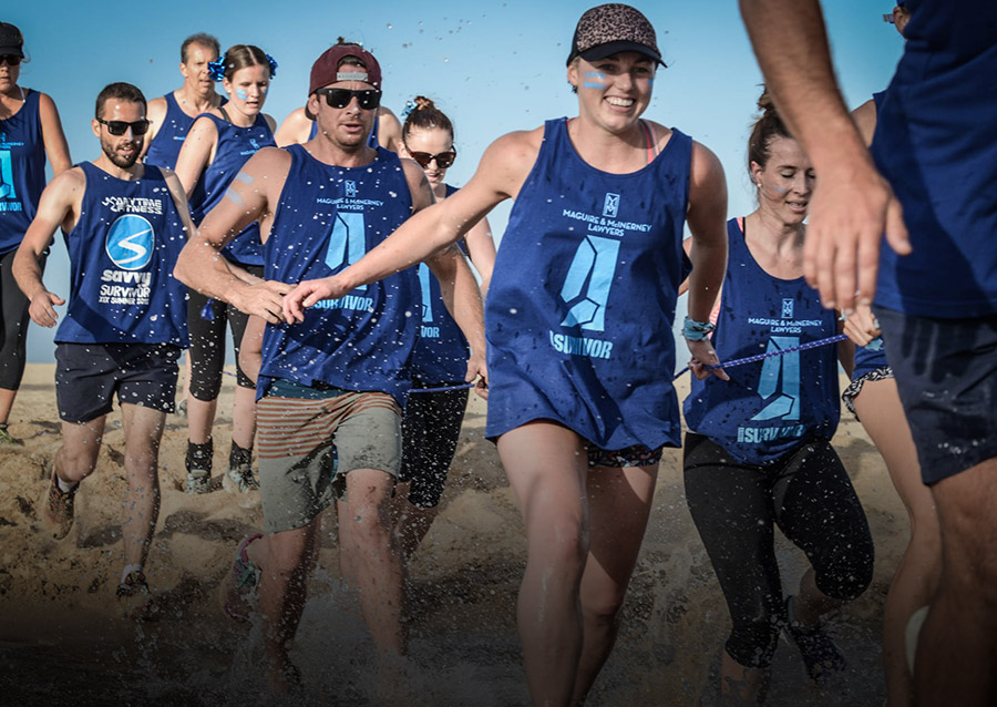 Group of people running on the beach