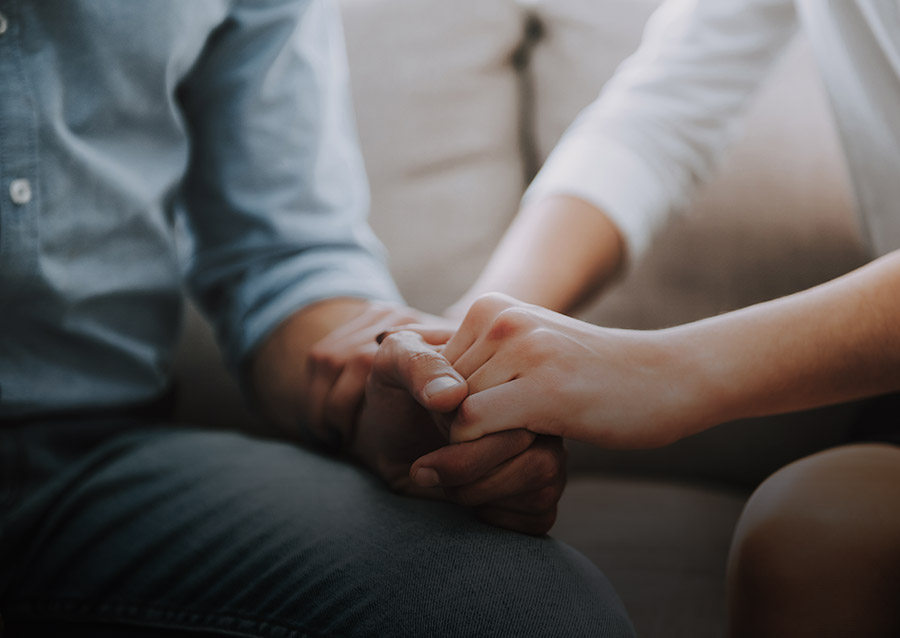 Couple’s hands holding each other