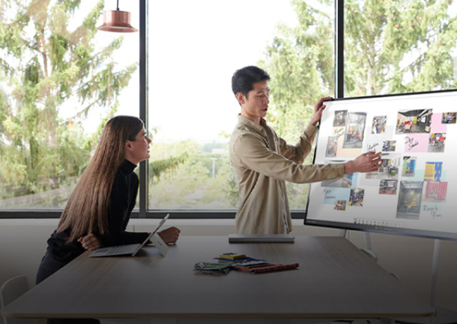 Male pointing at pictures in a large monitor screen