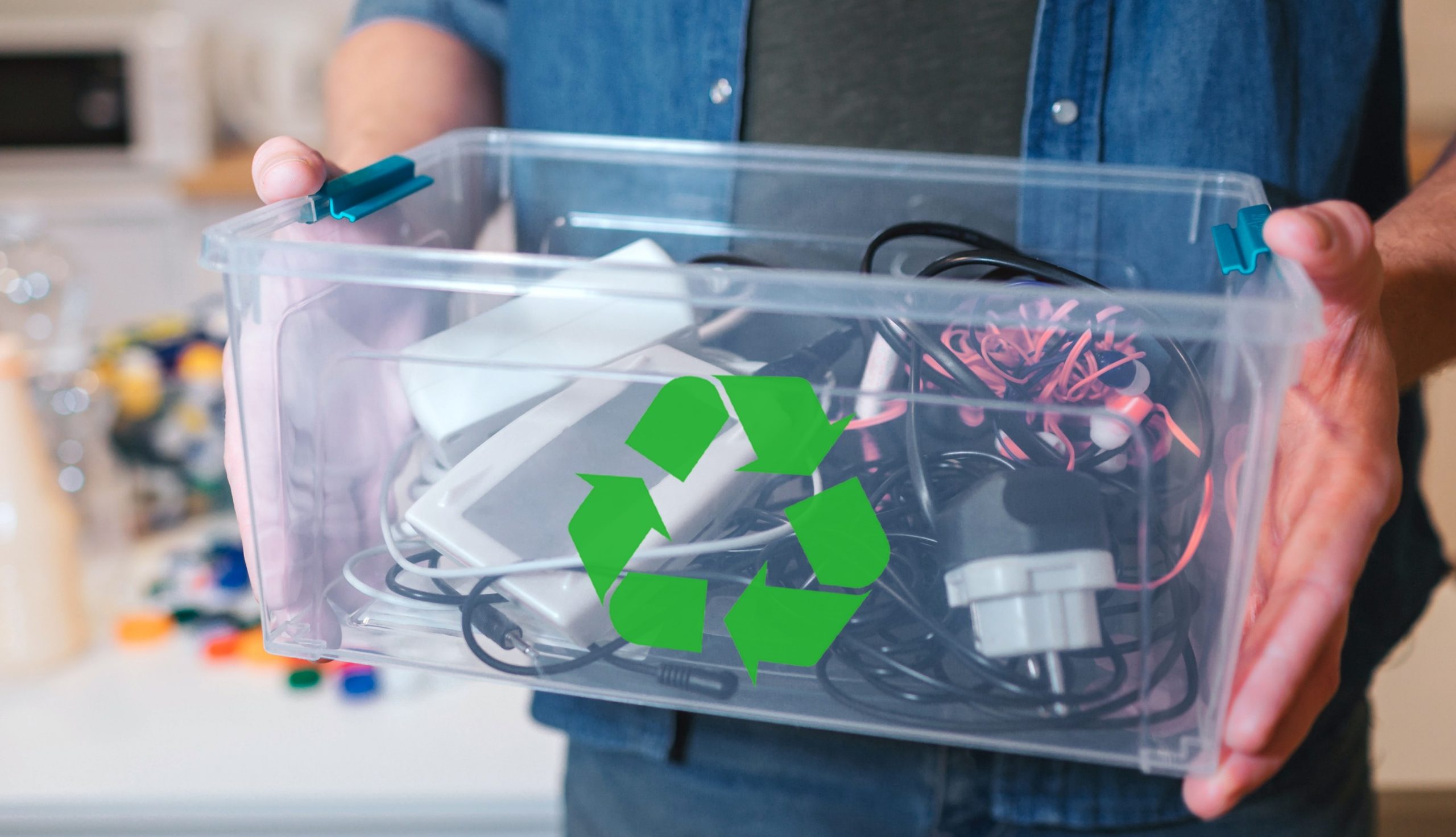 Man holding container of outdated technology for recycling